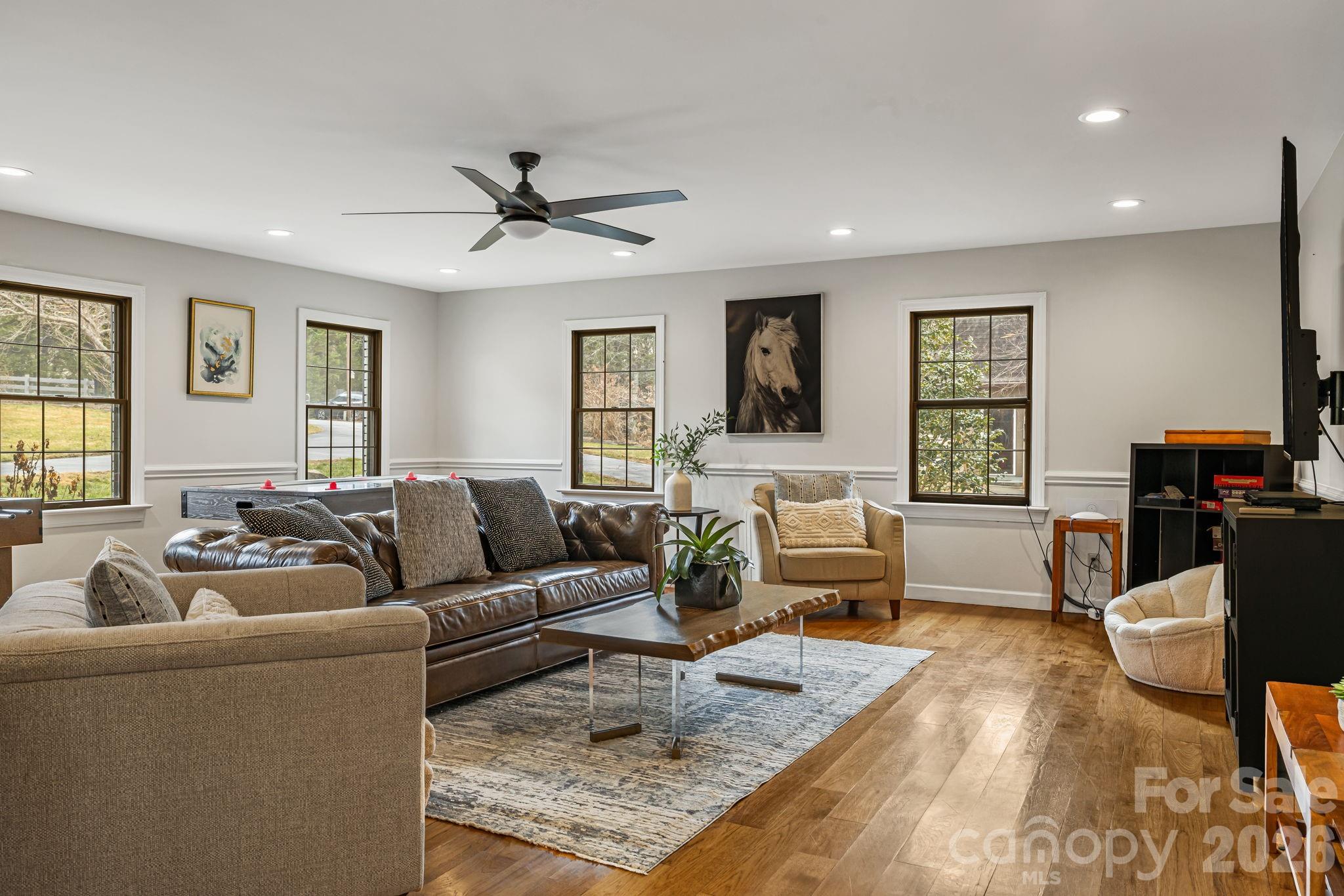 1236 Upper Brush Creek Road Fairview, NC 28730 - Photo 20 of 48 a living room with furniture and a wooden floor