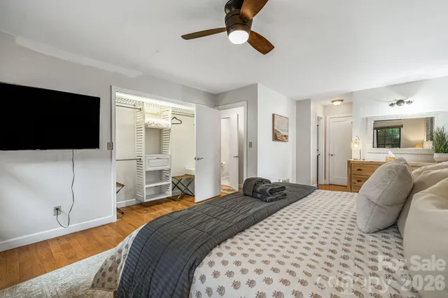 a bedroom with a bed window and a flat screen tv