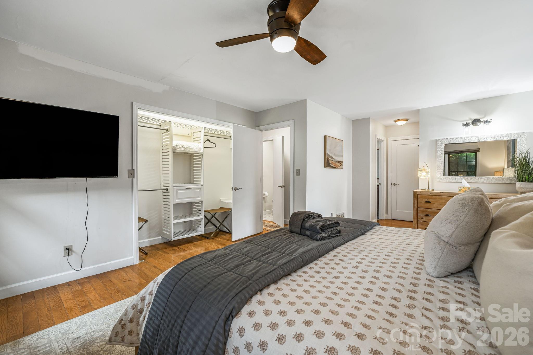1236 Upper Brush Creek Road Fairview, NC 28730 - Photo 25 of 48 a bedroom with a bed window and a flat screen tv