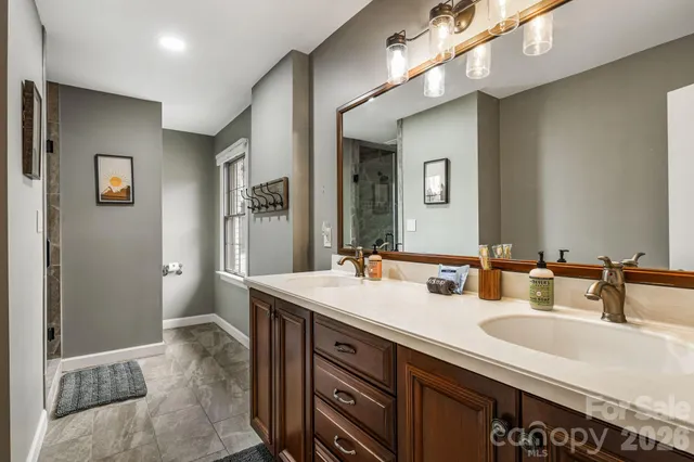 a bathroom with a sink double vanity and a mirror