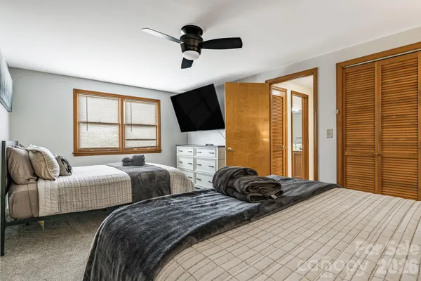 a bedroom with two beds and a large window