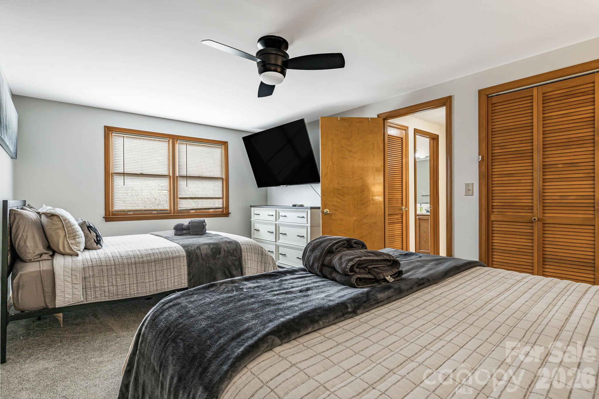 1236 Upper Brush Creek Road Fairview, NC 28730 - Photo 31 of 48 a bedroom with two beds and a large window