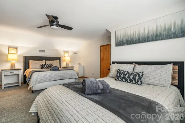 a bedroom with bed and a night stand