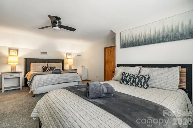 a bedroom with bed and a night stand