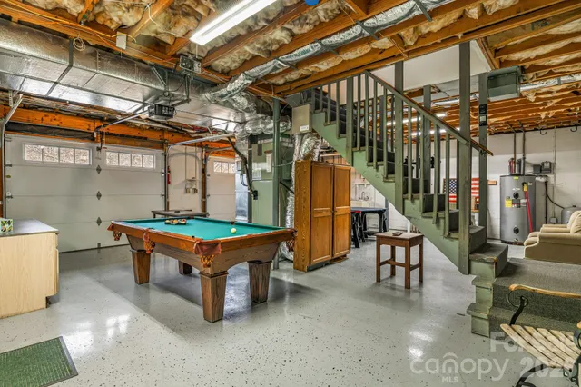 a backyard of a house with barbeque oven table and chairs