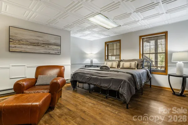 a bedroom with a bed couch and window