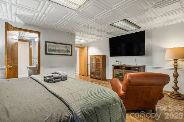 a bedroom with a bed and a flat screen tv