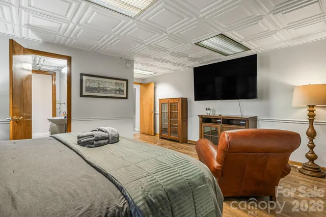 a bedroom with a bed and a flat screen tv