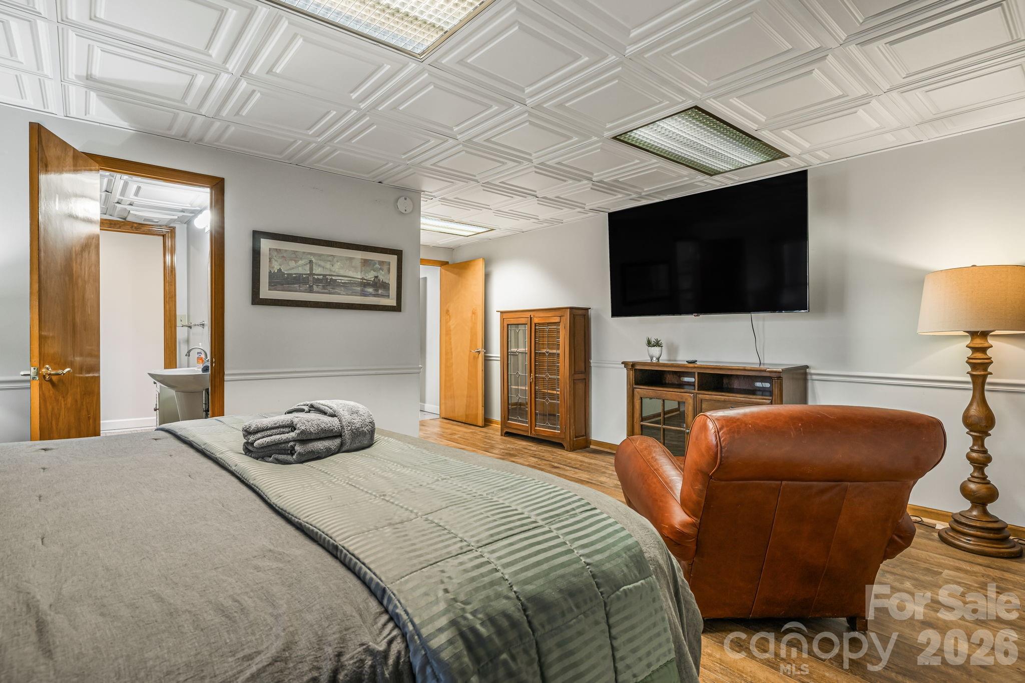 1236 Upper Brush Creek Road Fairview, NC 28730 - Photo 36 of 48 a bedroom with a bed and a flat screen tv