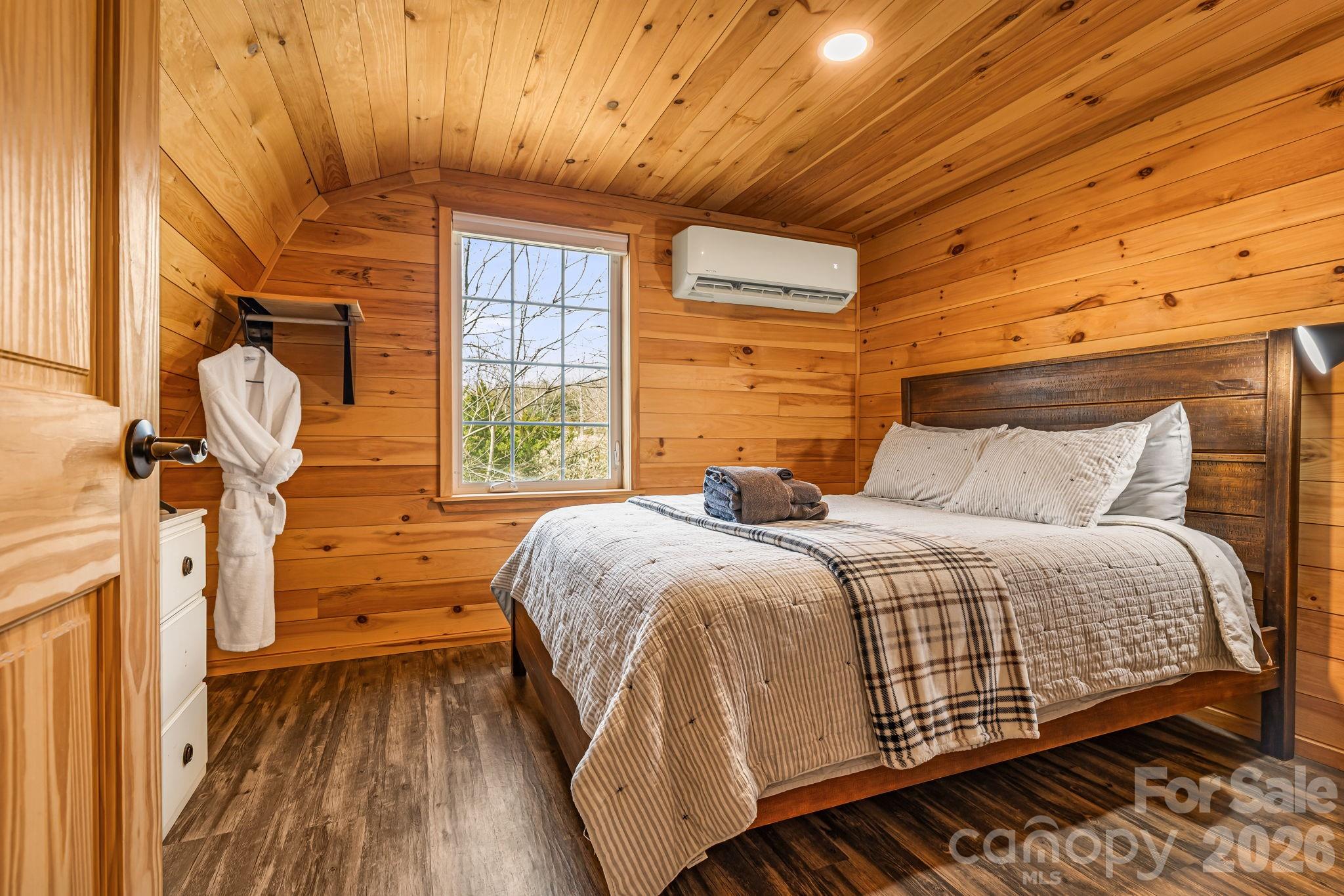 1236 Upper Brush Creek Road Fairview, NC 28730 - Photo 46 of 47 a bedroom with a bed and wooden floor