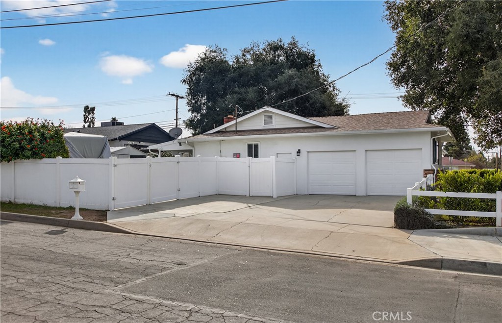 13689 Bryant Street Yucaipa, CA 92399 - Photo 4 of 30 a front view of a house with a yard and garage