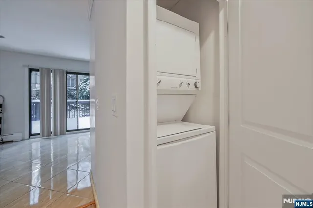 a view of a hallway with closet and a window