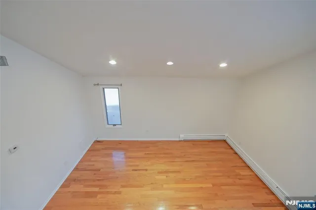 a view of a street with a wooden fence