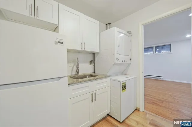 a kitchen with a refrigerator and cabinets