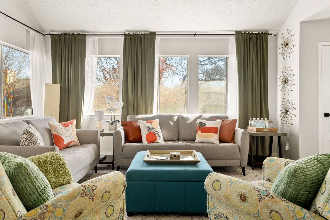 a living room with furniture and a large window