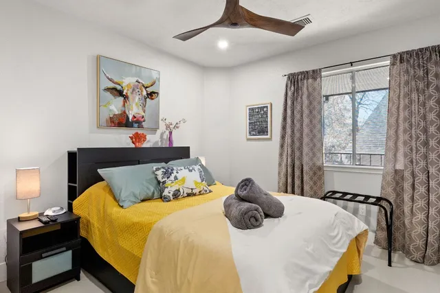 a bedroom with a bed and a chandelier