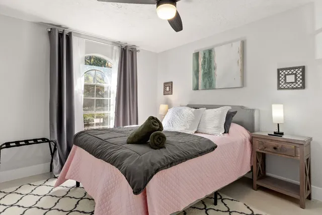 a bedroom with a bed and a mirror