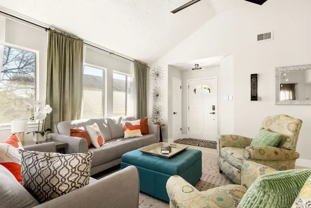 a living room with furniture couches and a large window