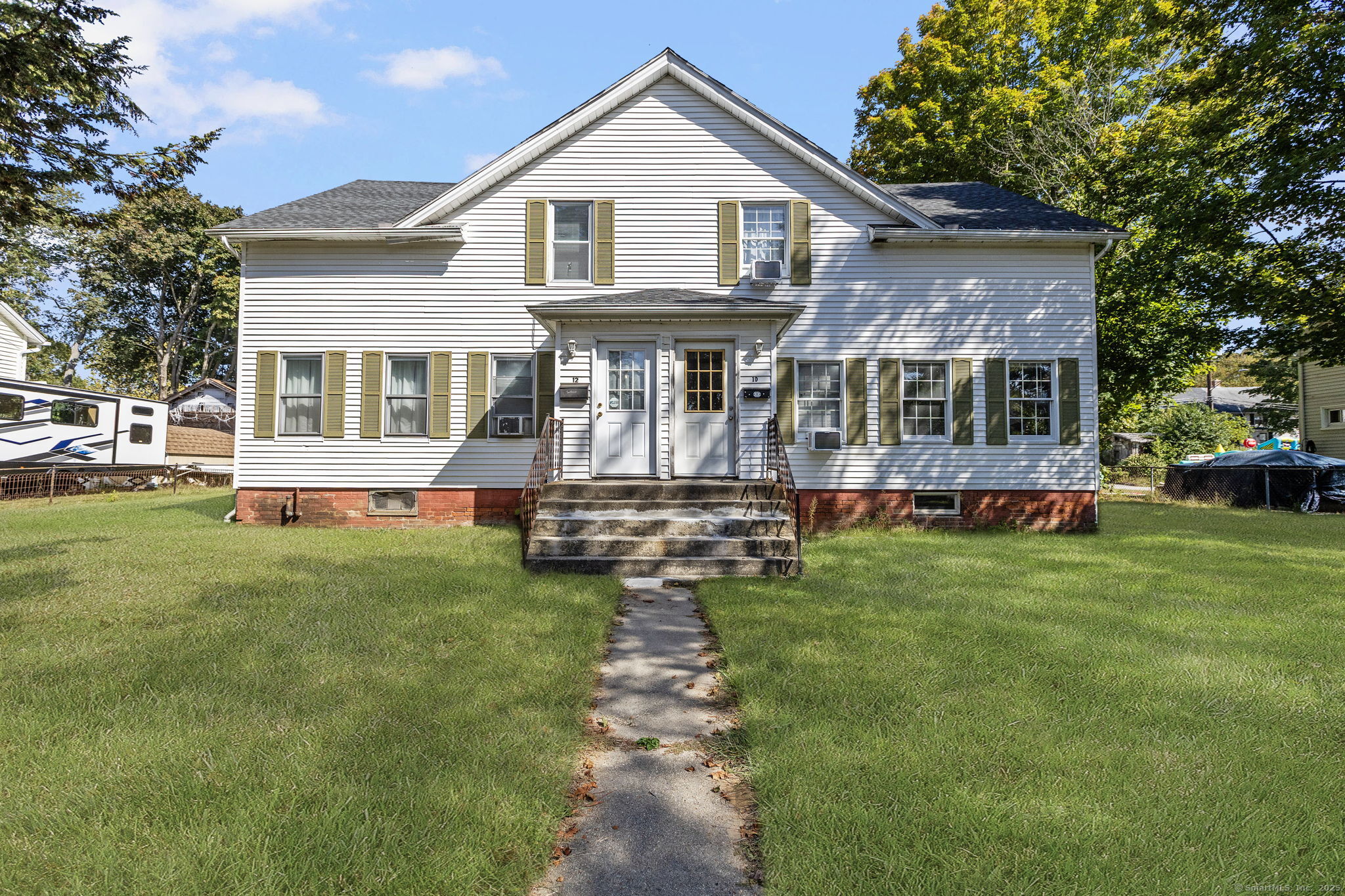 a front view of a house with a yard table and chairs