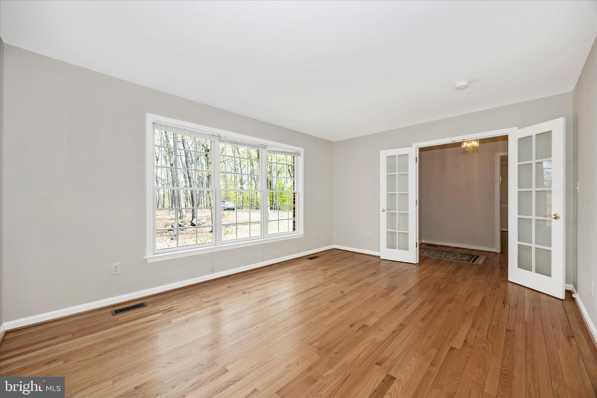 10393 Liberty Road Frederick, MD 21701 - Photo 19 of 47 an empty room with wooden floor and windows