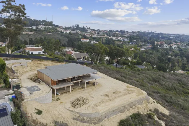 an aerial view of a house with a yard swimming pool and mountain view