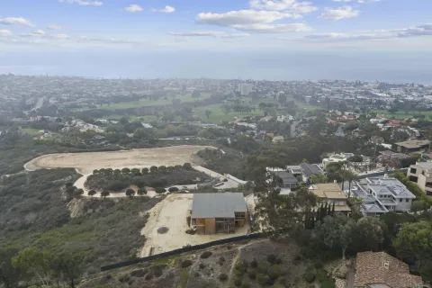 an aerial view of residential building with trees