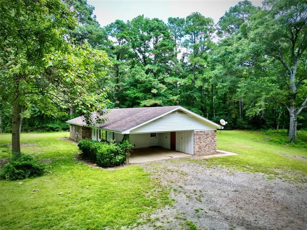 a house with green field in front of it