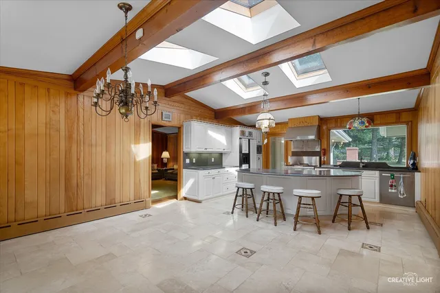 a view of a dining room with furniture and chandelier