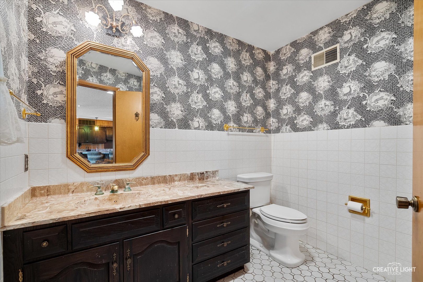 16323 Griswold Springs Road Plano, IL 60545 - Photo 22 of 55 a bathroom with a granite countertop toilet sink and mirror