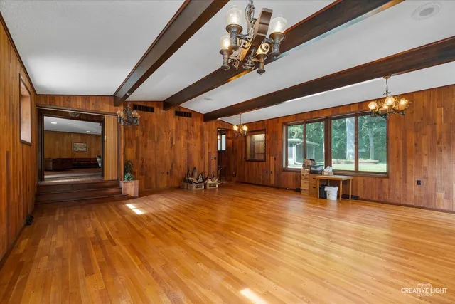 a view of a livingroom with hardwood floor and a ceiling fan