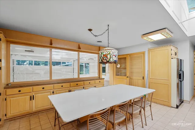 a view of a big room with entryway table and chairs