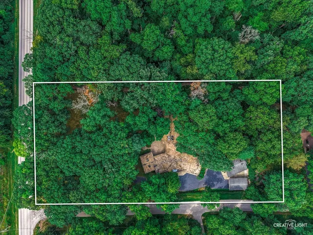 an aerial view of a house with yard