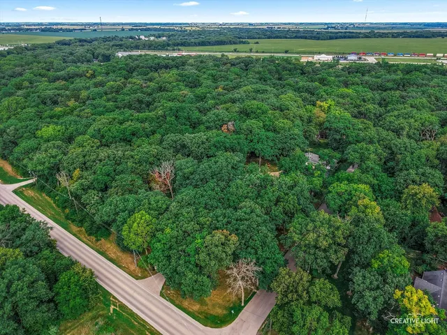 an aerial view of a house with yard
