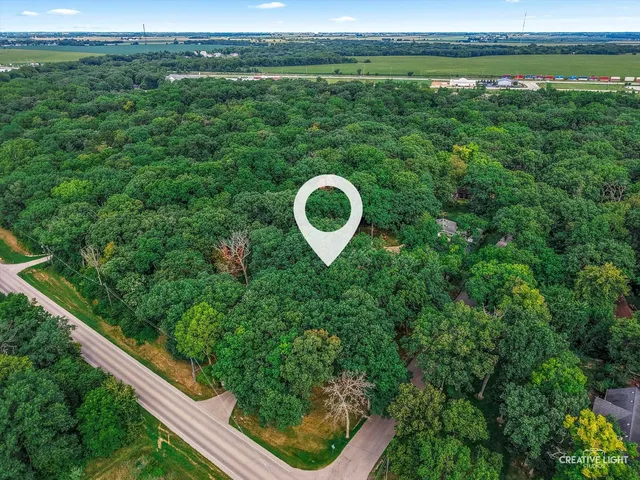 an aerial view of a house with yard