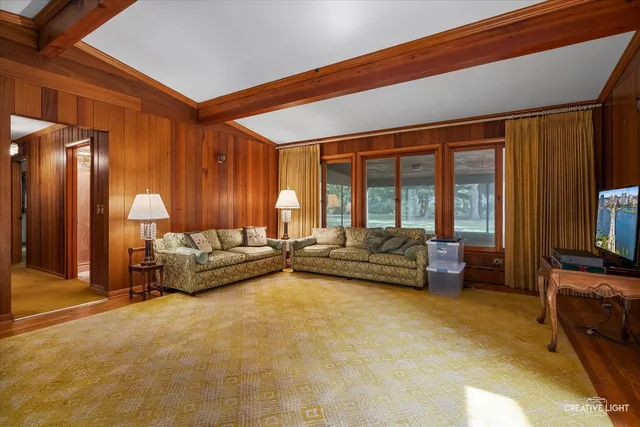 a bedroom with furniture and large windows