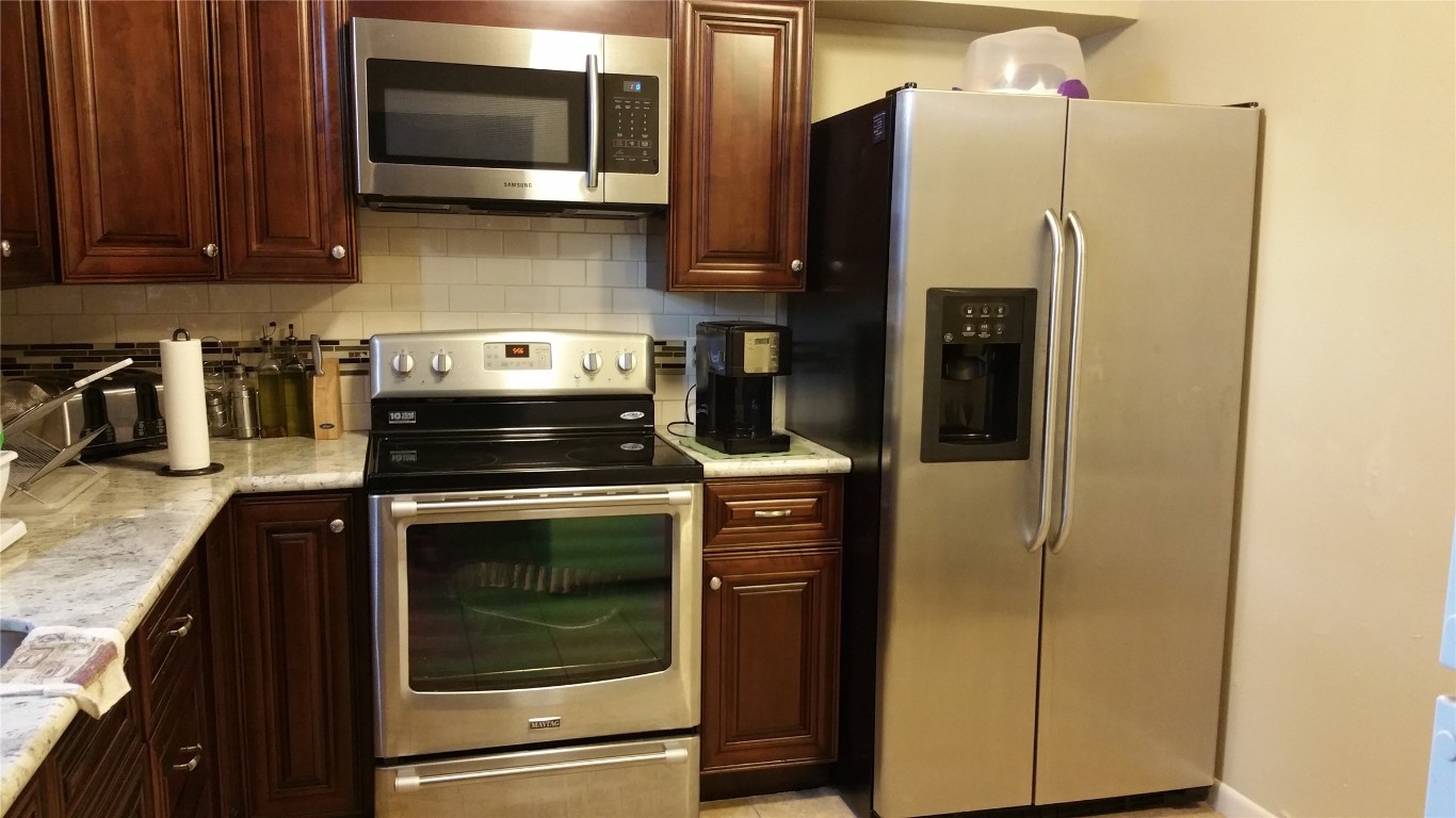 9217 Carousel Lane Houston, TX 77080 - Photo 13 of 38 a kitchen with a refrigerator stove and microwave