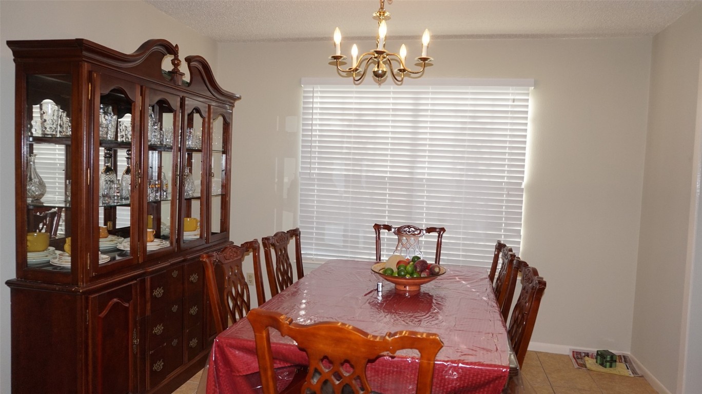 9217 Carousel Lane Houston, TX 77080 - Photo 16 of 38 a view of a dining room with furniture and chandelier
