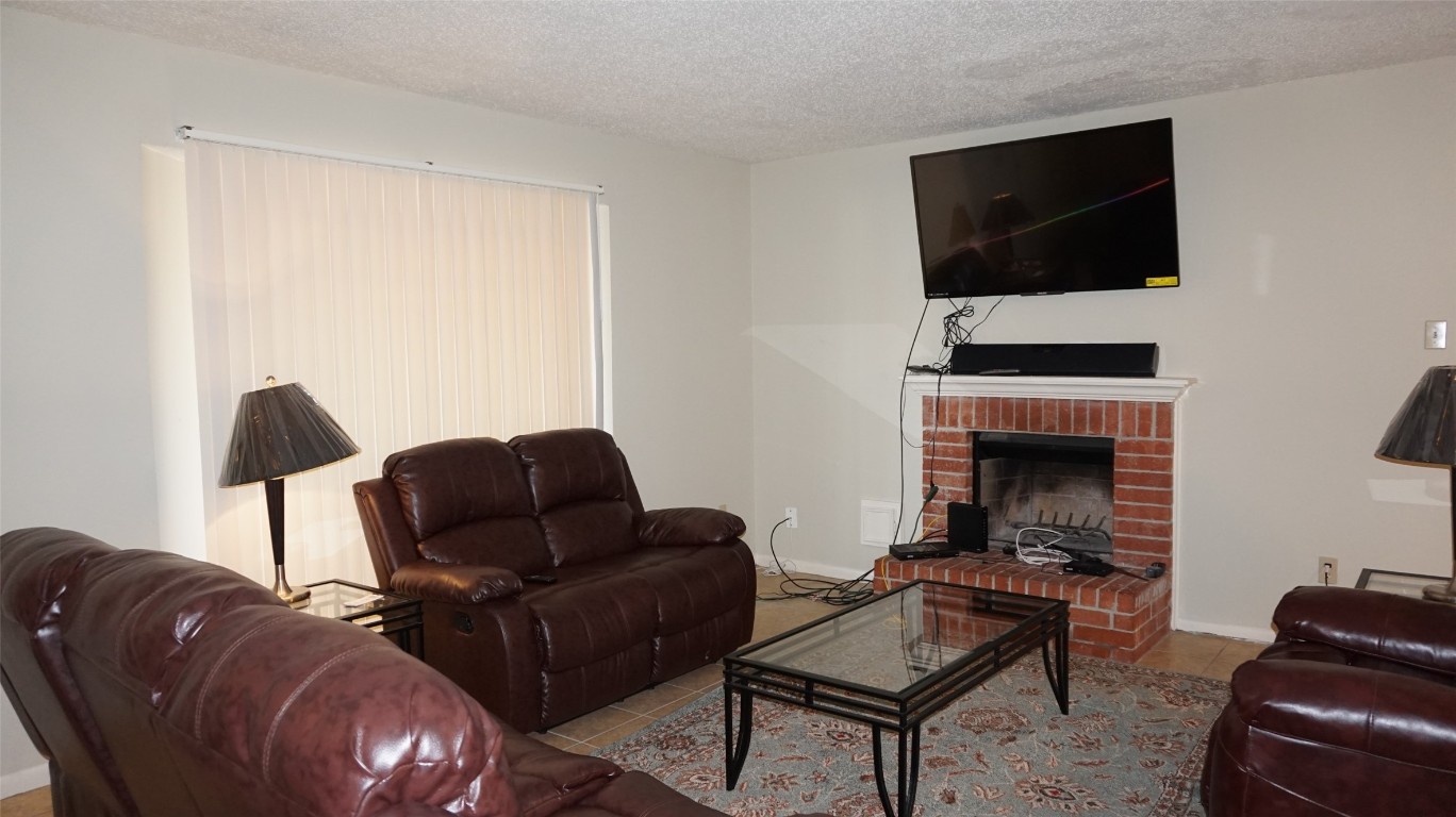 9217 Carousel Lane Houston, TX 77080 - Photo 17 of 38 a living room with furniture and a flat screen tv