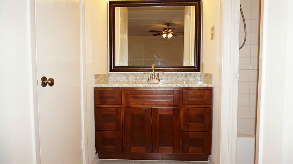 9217 Carousel Lane Houston, TX 77080 - Photo 29 of 38 a bathroom with a sink and a mirror