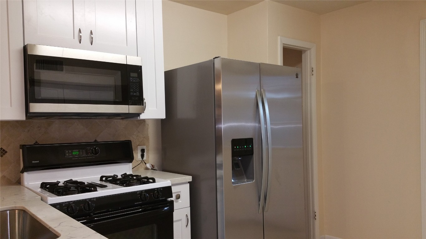 9217 Carousel Lane Houston, TX 77080 - Photo 38 of 38 a kitchen with stainless steel appliances granite countertop a stove and a microwave