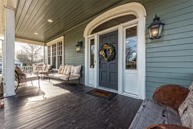 a view of a livingroom with furniture wooden floor and a chandelier