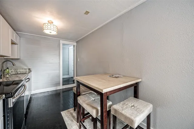 a bathroom with a toilet sink vanity and mirror