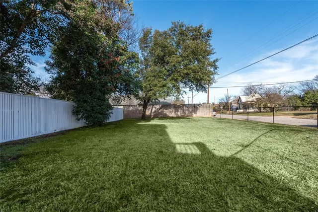 an aerial view of a houses with yard