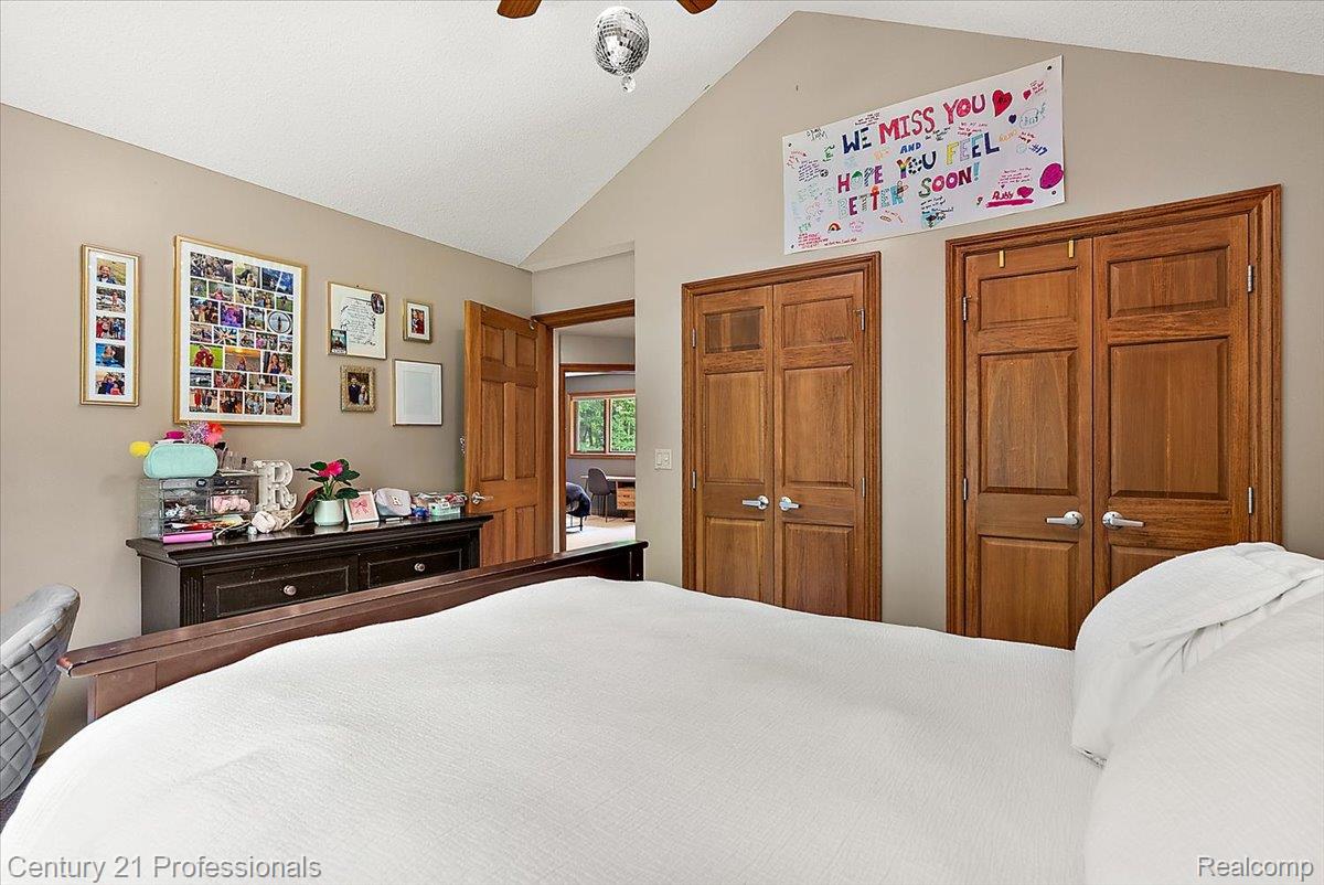 9867 Rainbow Ridge Drive Schoolcraft, MI 49087 - Photo 40 of 82 Vaulted ceiling bedroom featuring light tan walls and natural wood-finish doors