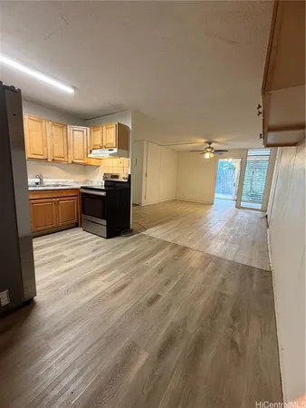 a kitchen with granite countertop a refrigerator and a sink