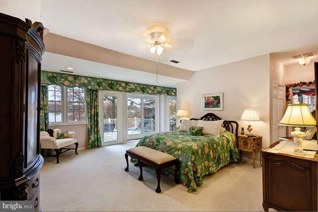 310 South River Landing Road, Unit 310 Edgewater, MD 21037 - Photo 14 of 30 a bedroom with a bed couch and large windows