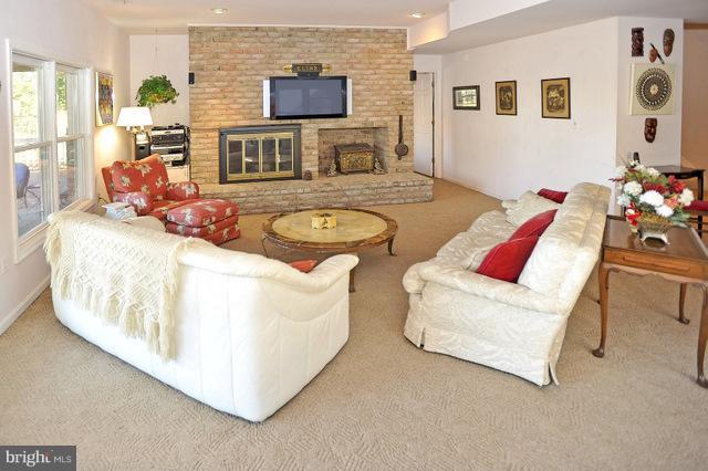 310 South River Landing Road, Unit 310 Edgewater, MD 21037 - Photo 23 of 30 a living room with furniture and a flat screen tv