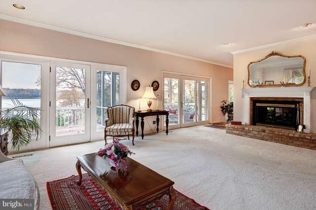 310 South River Landing Road, Unit 310 Edgewater, MD 21037 - Photo 8 of 30 a living room with furniture a large window and a fireplace