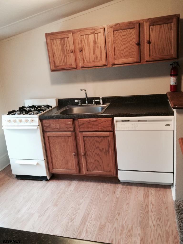 237 Marlin Road Absecon, NJ 08201 - Photo 20 of 25 a kitchen with granite countertop a stove a sink and a microwave