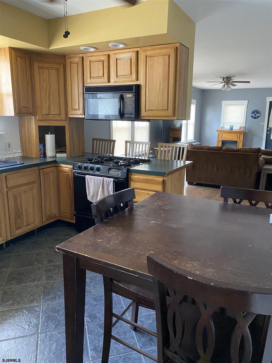 237 Marlin Road Absecon, NJ 08201 - Photo 8 of 25 a kitchen with stainless steel appliances granite countertop a table chairs sink and cabinets